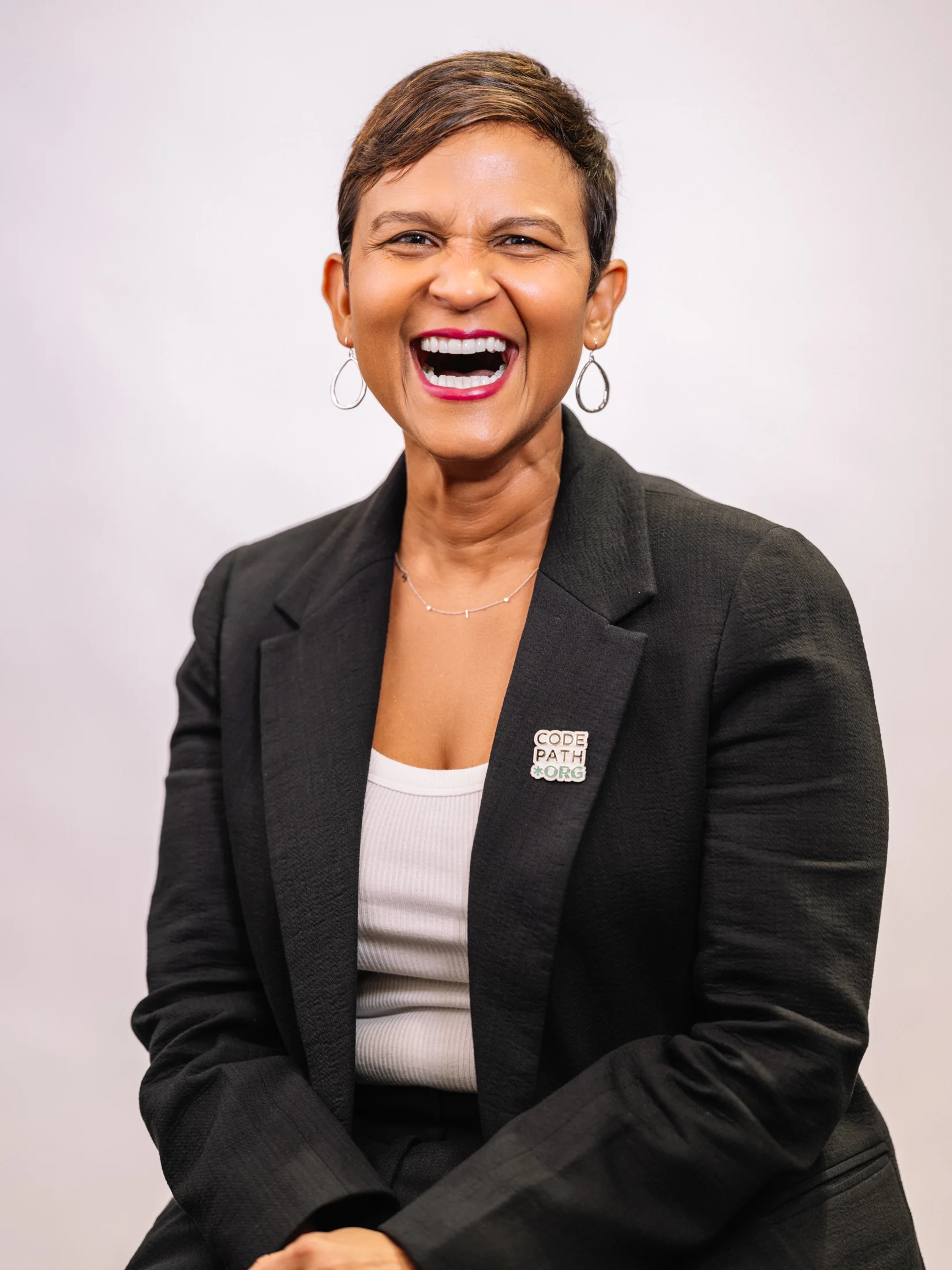 CodePath portrait of Karletti Medina laughing in a dark blazer