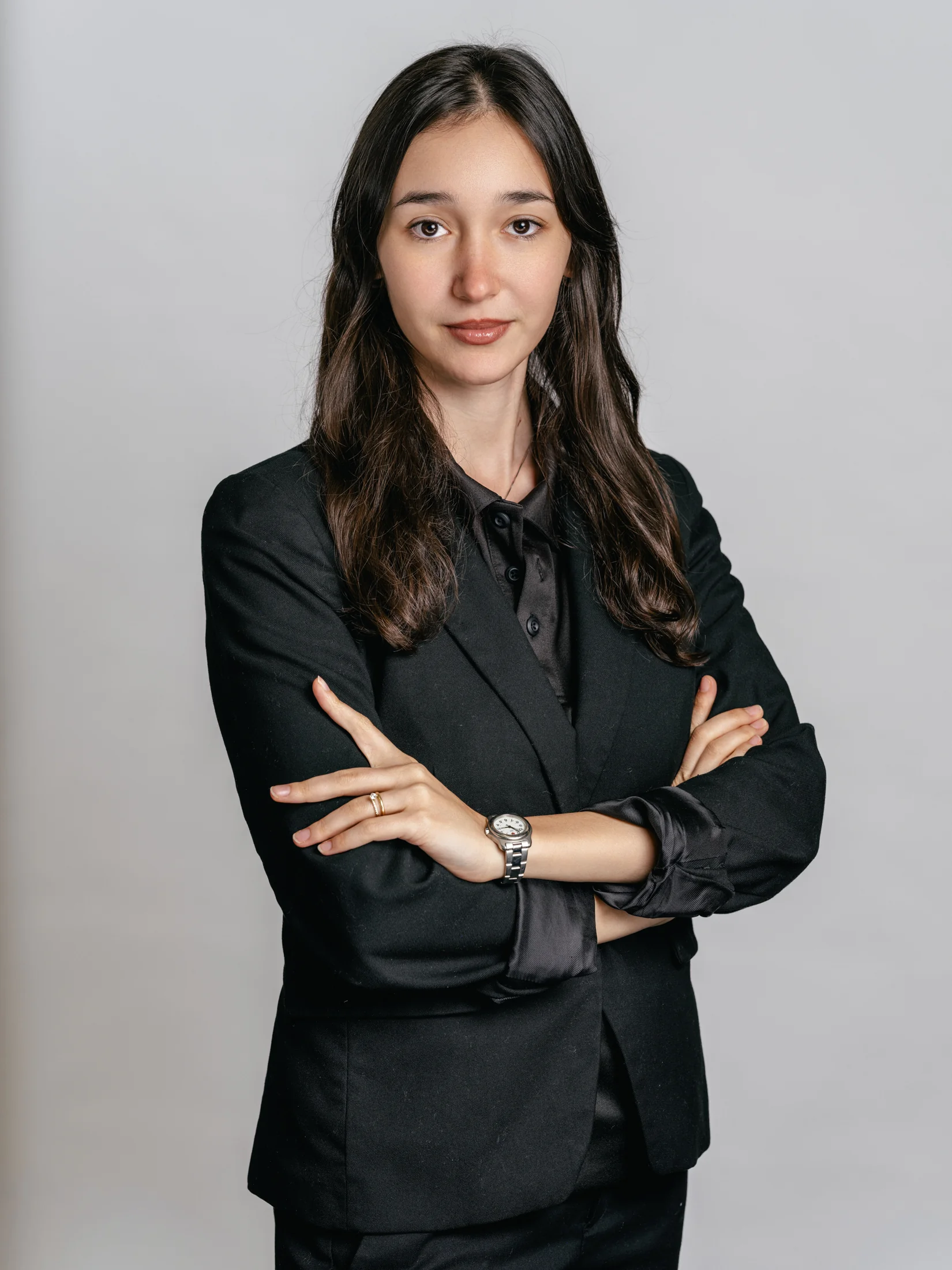 MDC staff portrait in a black shirt with folded arms against a grey background
